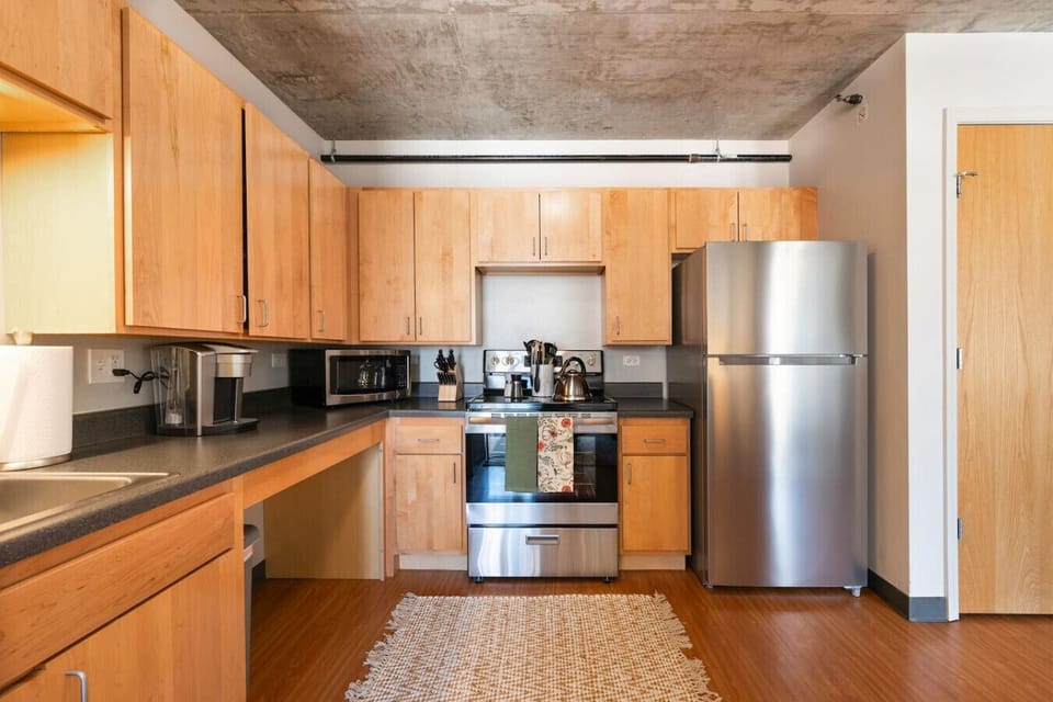 Fully equipped modern kitchen with stainless steel appliances and ample counter space.