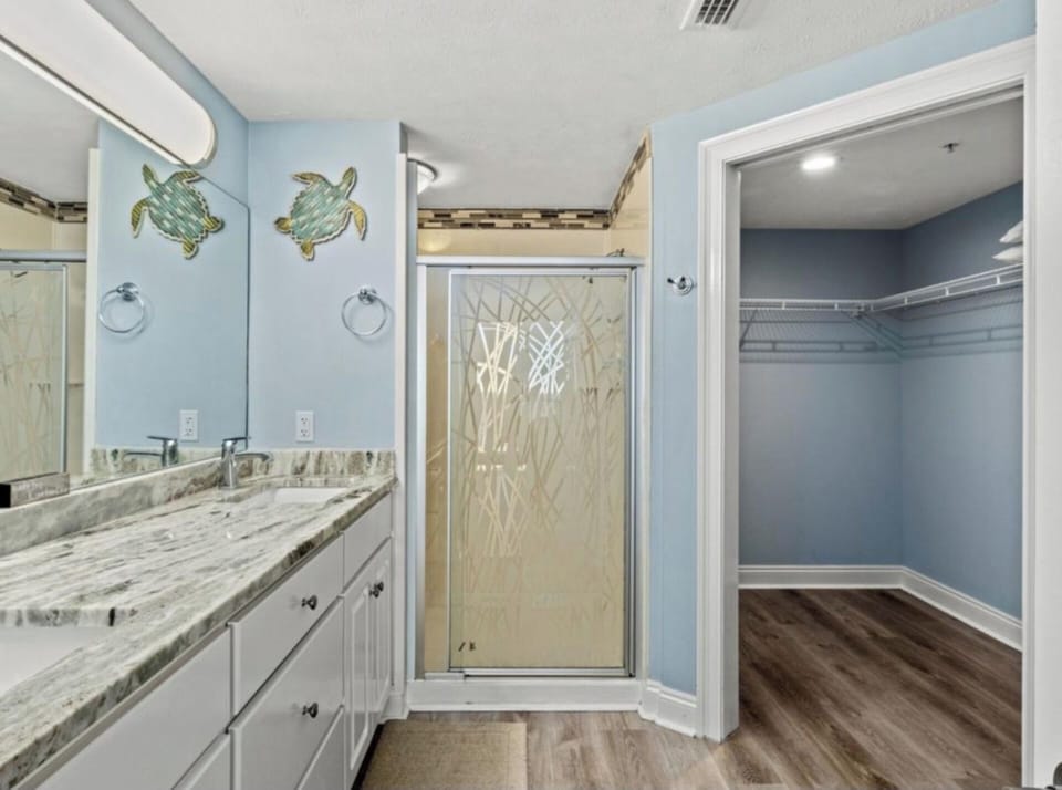 Master bathroom with walk in shower and large walk in closet