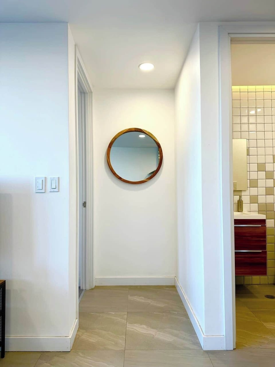 Por éste pasillo con el espejo circular entras a la habitación principal.