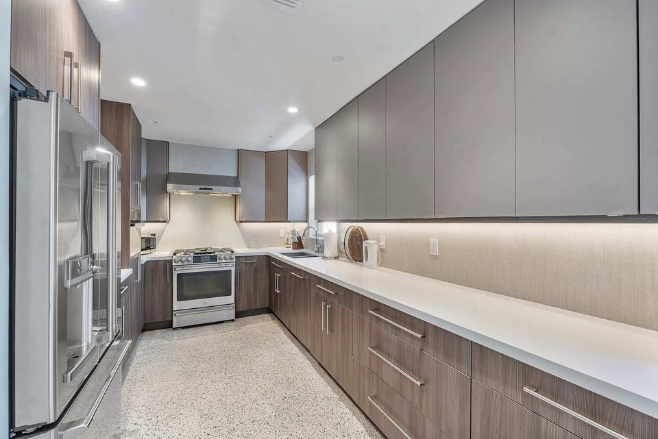 Enjoy the convenience of a spacious kitchen with a large fridge and wide counter space for effortless meal preparation