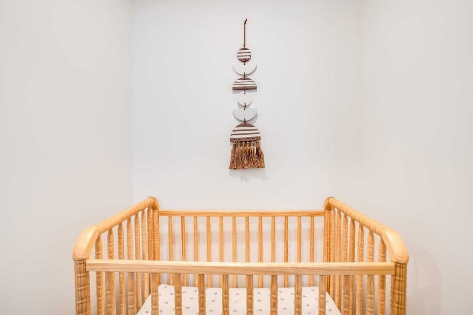 Crib ready for a baby or toddler.  This bedroom is in the  basement, so it can be dark and quiet! 