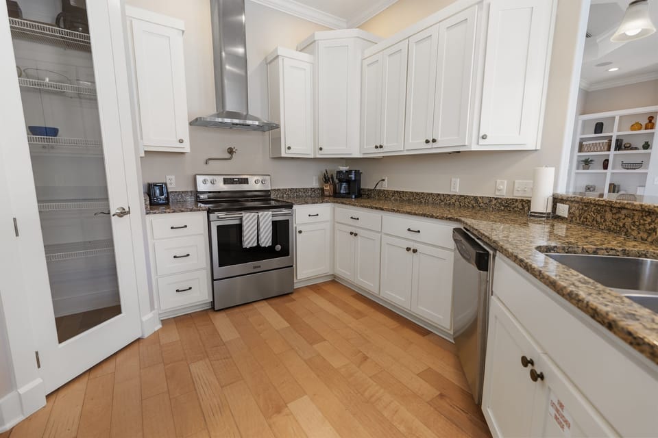 Step into your fully equipped gourmet kitchen with granite counters, stainless appliances, and pantry storage for memorable cooking.