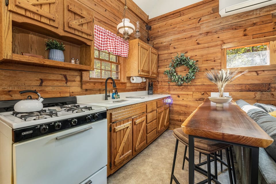 Step into our fully stocked kitchen, where you’ll find barstool seating for four with a bar overlooking the living room area.