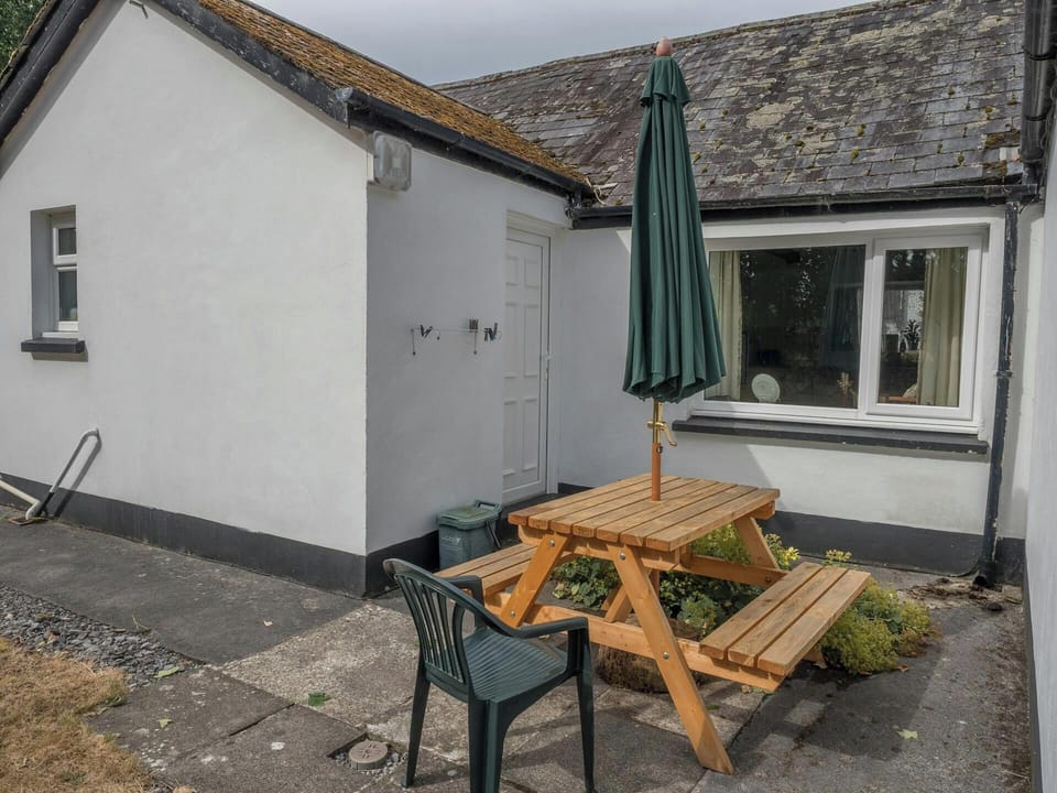 Picnic table with parasol and garden chair