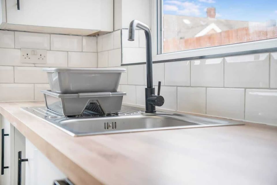 Kitchen equipped with all essentials, including a washer & dryer, oven, fridge and full cookware set.
