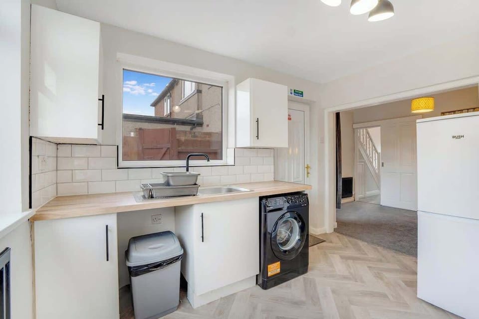 Kitchen equipped with all essentials, including a washer & dryer, oven, fridge and full cookware set.