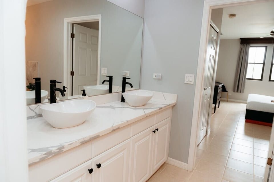 Beautiful private vanity with a spacious mirror and tub.