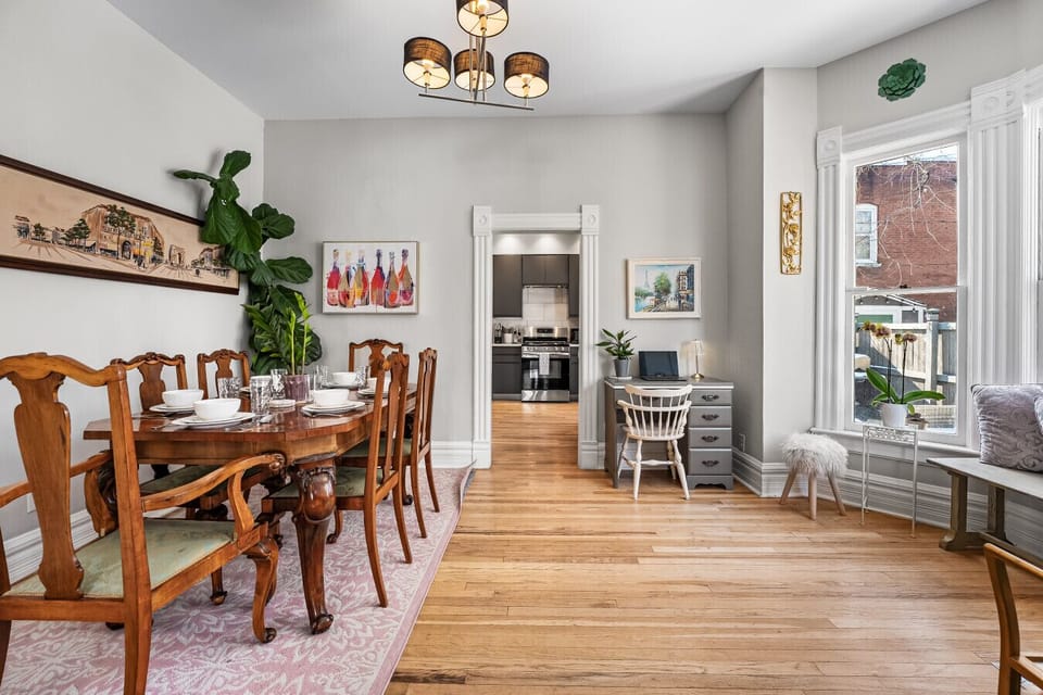 The dining room connects the kitchen to the living room. Complete with 6 person dining table, desk, and bay window