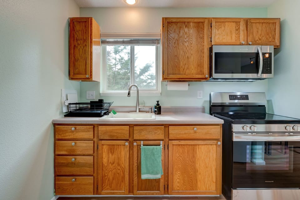 Kitchen with new stove and microwave.