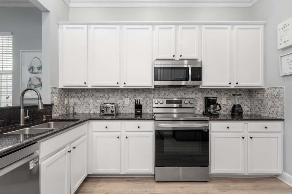 The kitchen comes with new stainless appliances.