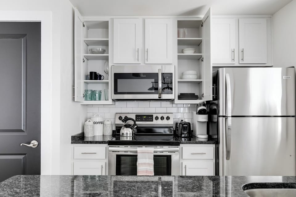 Kitchen: Modern fixtures and ample space make cooking a delight in this stylish area!
