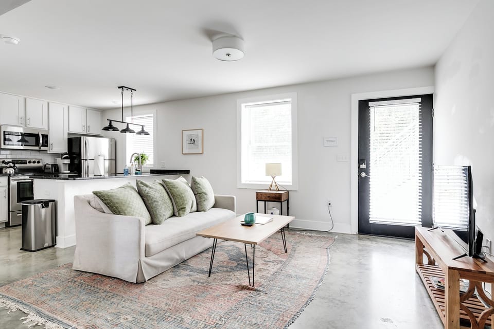 Living Room: Sunlit space with chic decor and open kitchen views for memorable gatherings!