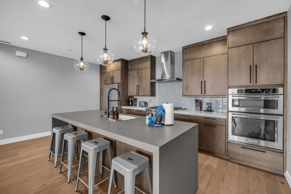 The spacious island provides the perfect spot for breakfast, evening cocktails, or helping prepare meals while staying connected with family and friends.