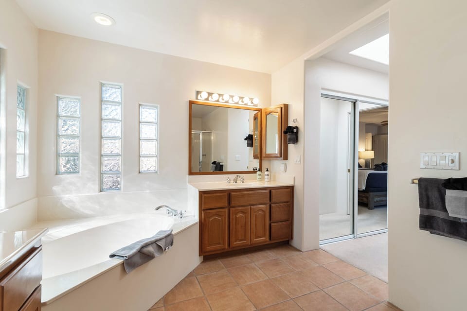 Private bathroom offers two vanities, a soaking tub and a separate shower.
