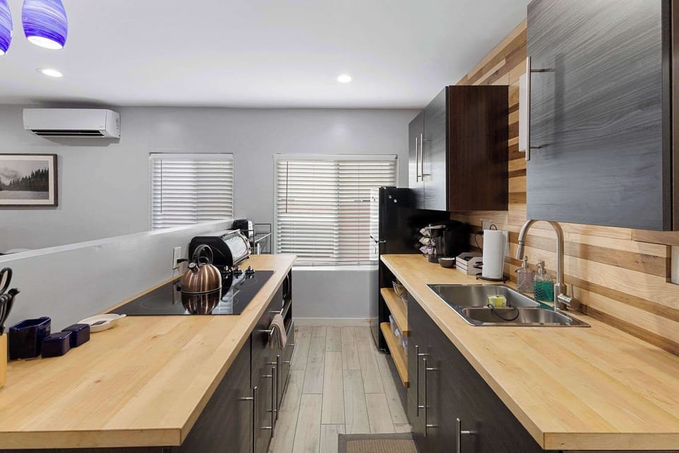 The kitchen has a new range with stove and oven, microwave, toaster oven and refrigerator.