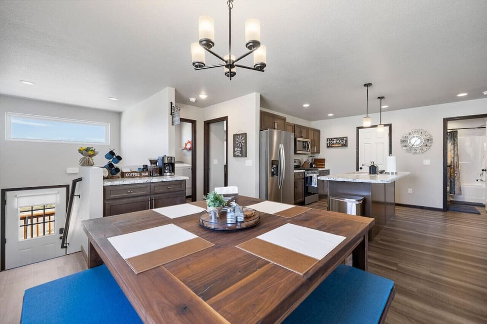 The spacious dining and kitchen area is perfect for a family or group of 6, offering a cozy spot to enjoy meals and gather together.