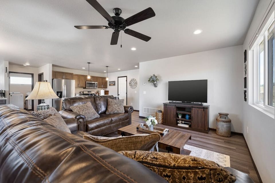 Relax in the spacious living room, comfortably accommodating up to 6 guests, and enjoy your favorite shows on the TV for a cozy night in.