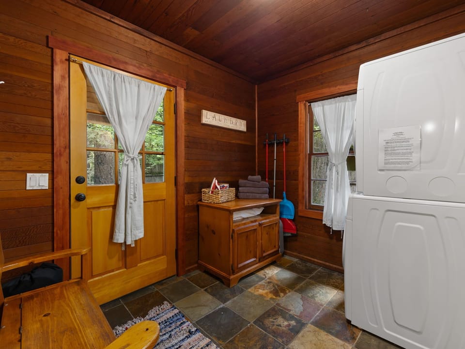 Keep things fresh with your own private laundry setup—stacked washer/dryer, natural light, and rustic charm make chores feel like part of the getaway.