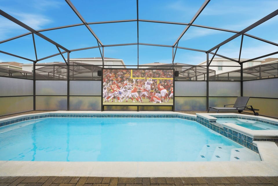 Escape to your private pool oasis with crystal-clear waters, ideal for relaxation. The spacious screened enclosure offers a serene setting, perfect for unwinding in comfortable chairs or enjoying evening entertainment on a large.