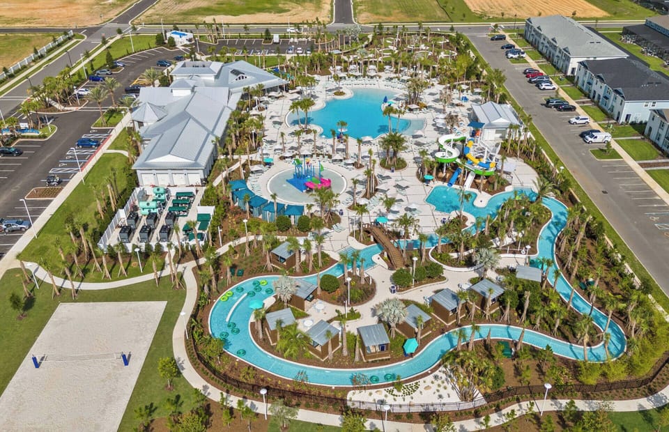 Discover a vibrant outdoor oasis with beautiful blue pools, lush palm trees, and inviting seating. Enjoy playful splash pads and a winding lazy river, offering relaxation and fun for guests of all ages.