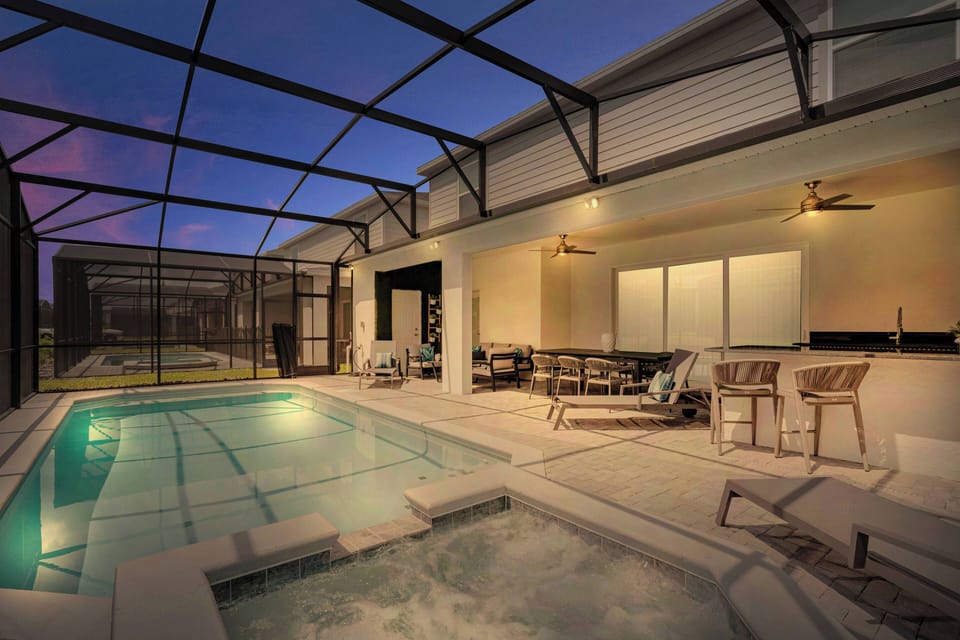 Discover your personal oasis featuring a beautiful pool and calming spa, enhanced by modern tiles. The spacious area invites relaxation, with overhead fans and soft lighting providing a serene atmosphere for evening swims or.