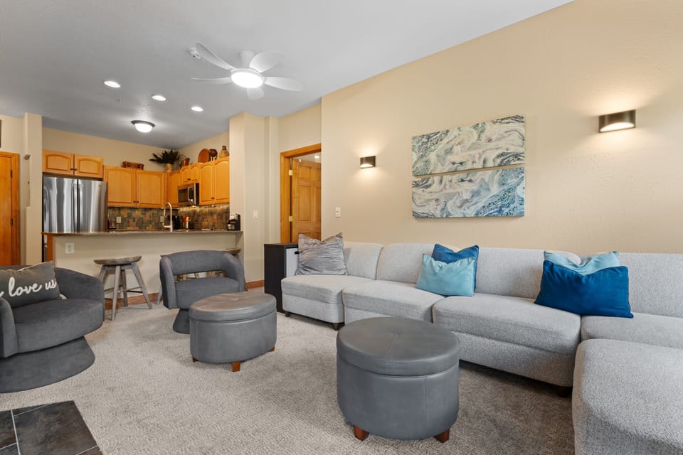 Settle into your inviting living space with plush seating and coastal accents. The open layout connects you to the kitchen, perfect for relaxing evenings together.