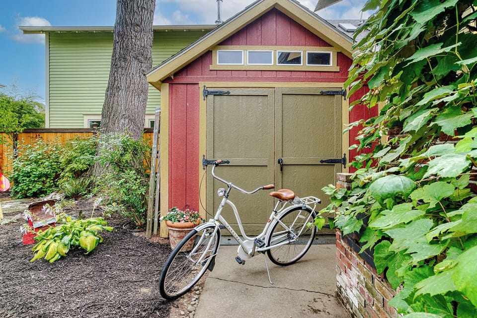 There are two bicycles, helmets, locks, and a tire pump in the shed.