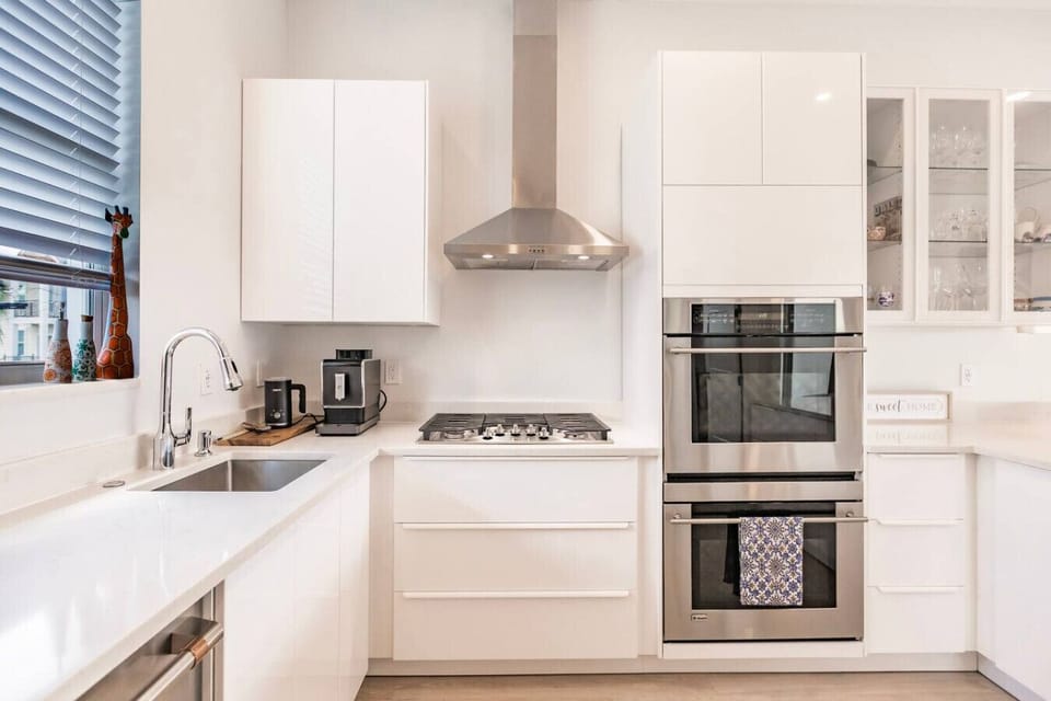 Gas stove top, double oven (monogram), Modern Espresso maker grinds fresh beans for every cup. Detached Foam maker for the perfect cappuccino every time. The microwave is above the ovens.