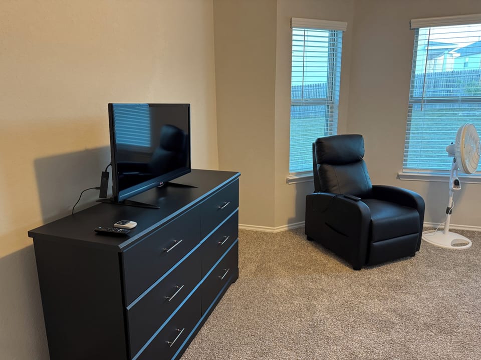 Master bedroom dresser and recliner.