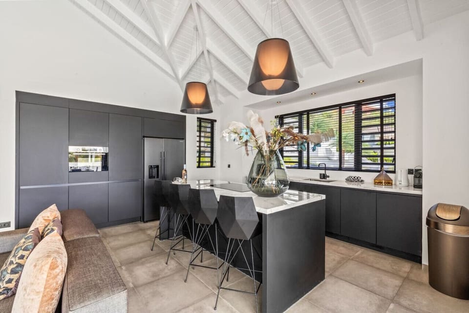 Welcome to your chic culinary retreat! This modern kitchen is perfect for creating delicious meals and enjoying quality time with friends.