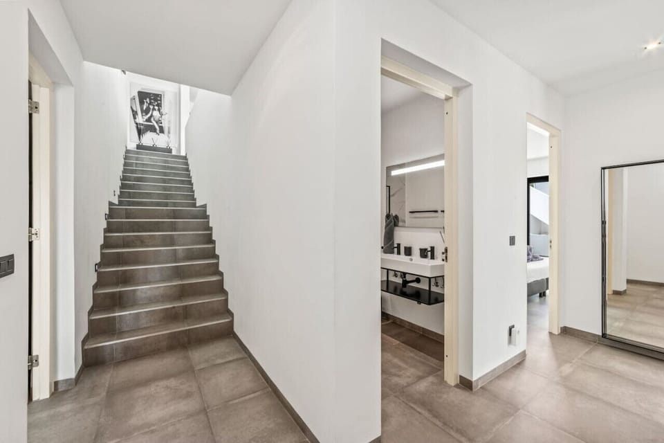 Welcome to your stylish sanctuary! Ascend the sleek staircase to discover a world of comfort and modern design. Each step brings you closer to the cozy spaces waiting to be explored!