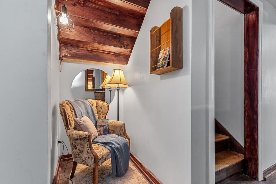 Escape to this charming basement reading nook—a perfect little corner to curl up with a book and unwind.