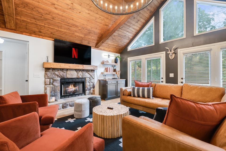 This stunning retreat features a gorgeous wood and bean ceiling, coxy gas fireplace, a luxurious leather section and spacious dining area with seating for 12. 