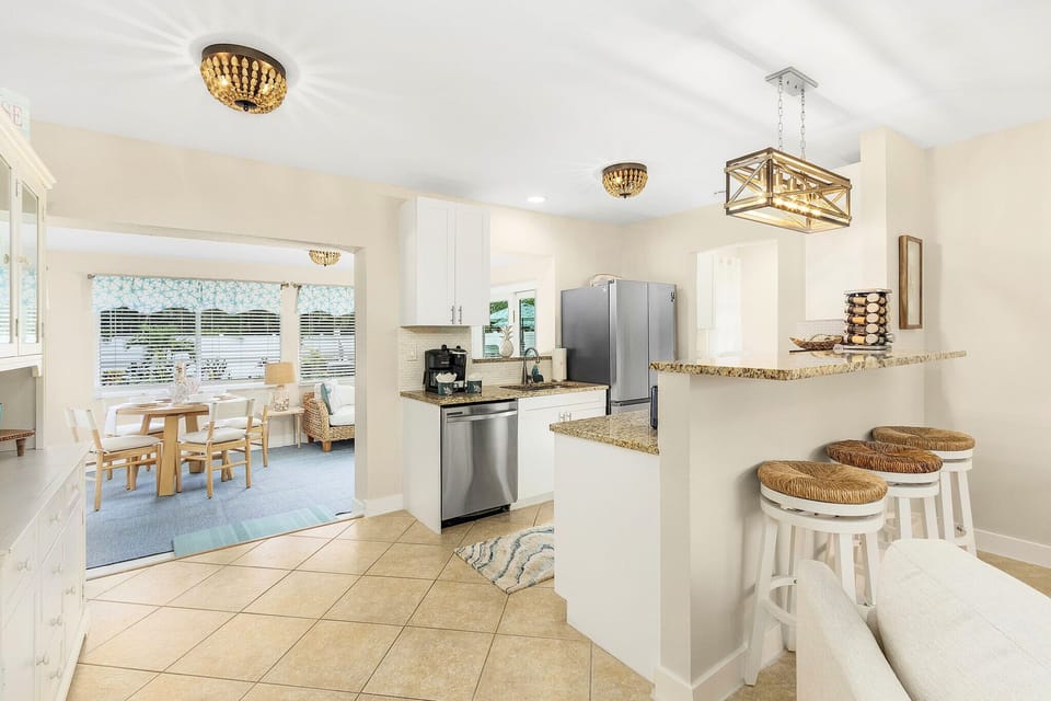 Seamlessly transition from cooking to dining in this open and airy space.  The kitchen and dining area are designed for easy flow and comfortable gatherings.