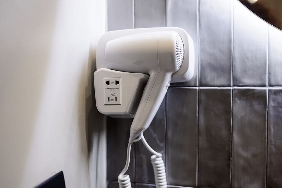 Shower, hair dryer, slippers, towels