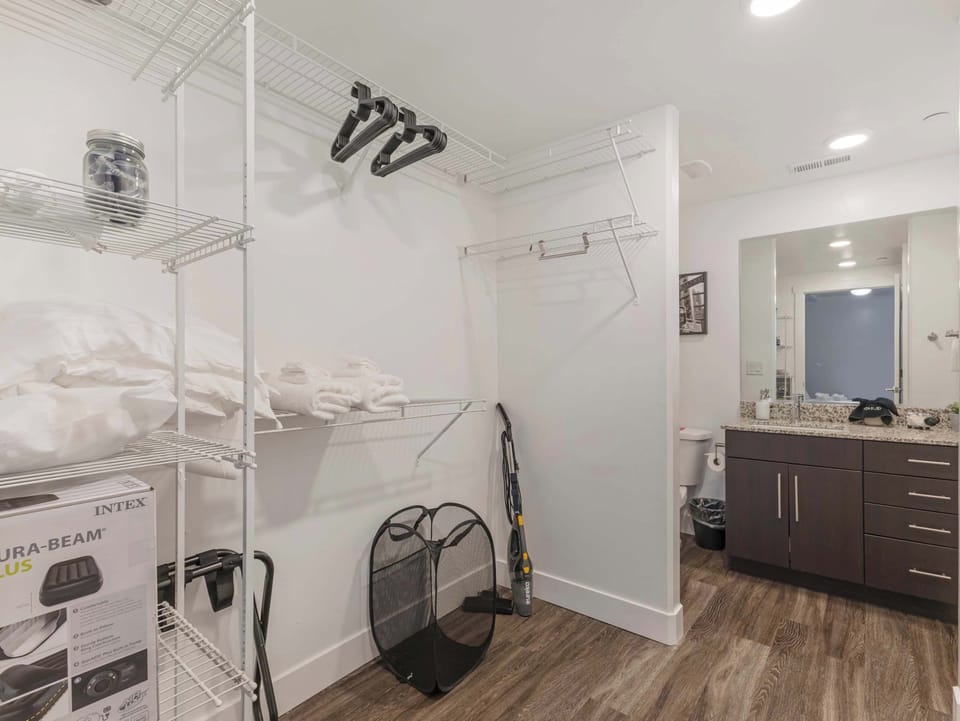 Walk-in closet area w/ shelving, hangers & extra storage space