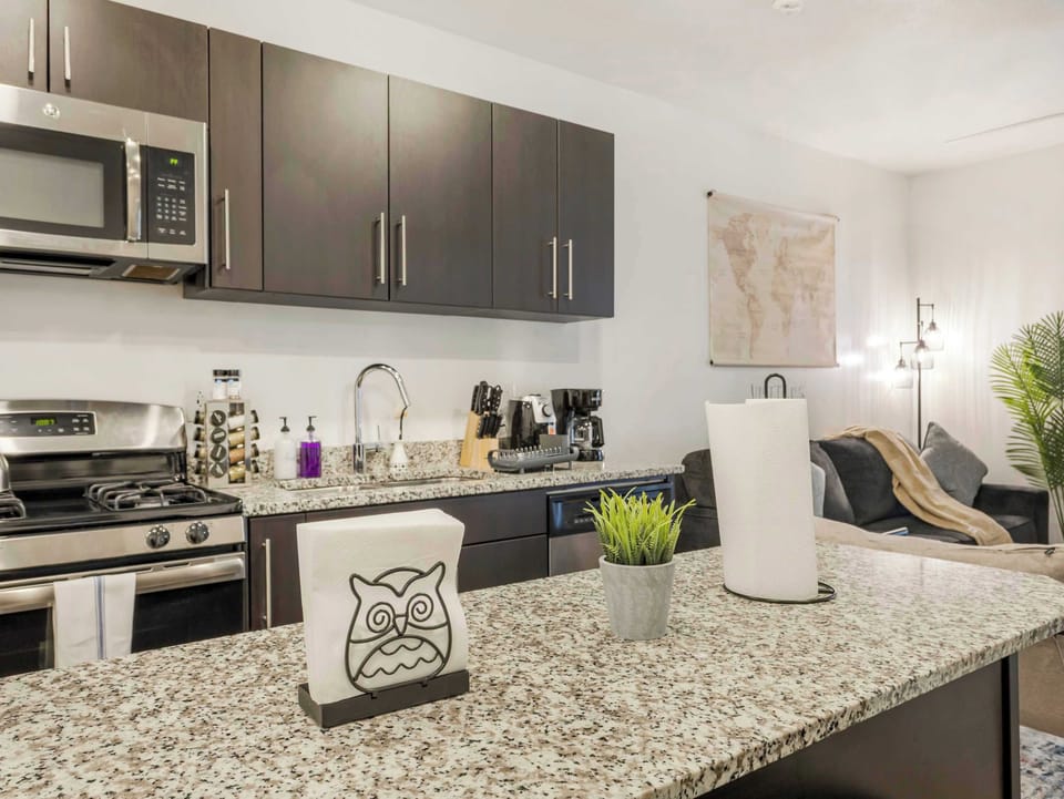 Kitchen island w/ granite countertop perfect for prepping meals or enjoying coffee