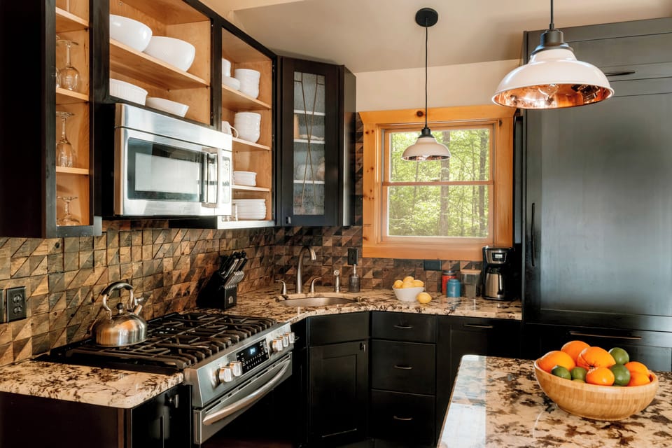 Tidy open shelving, high-end appliances, stocked w/ all cooking essentials.