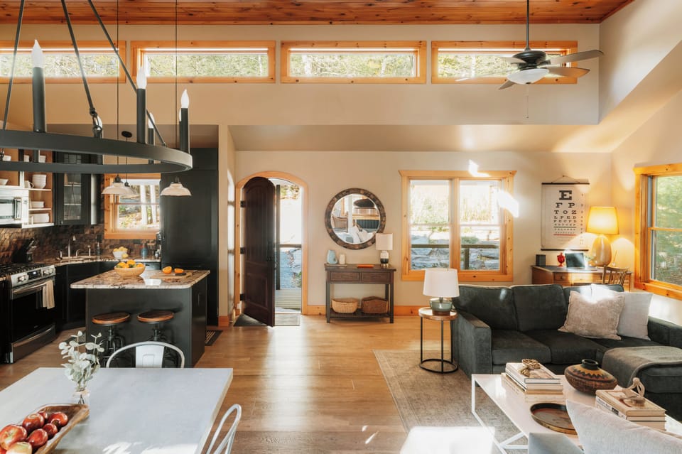 Open-concept kitchen faces the sun-drenched great room's dining & living areas.