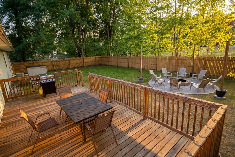 Private, fenced in back yard with grill, outdoor seating and fire pit with string lights ready to enjoy.