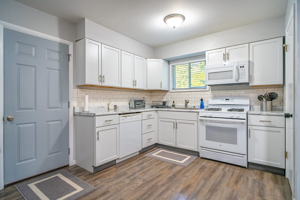 Large kitchen with plenty of pots, pans and utensils for you to make all of your meals or snacks.