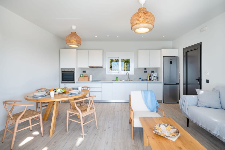 Living area with integrated kitchen%2C dining table and sitting area