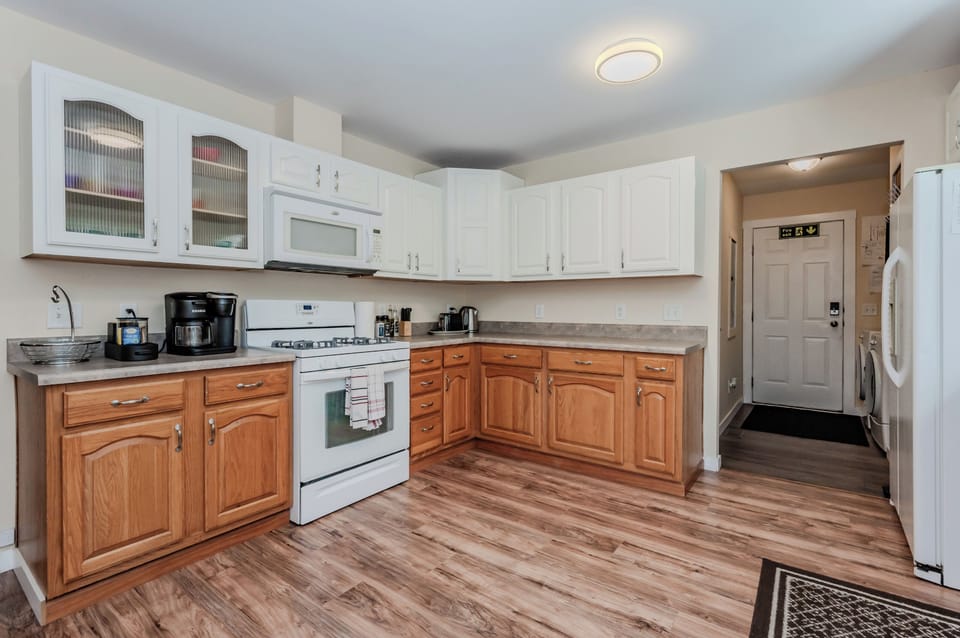 The bright and open kitchen, complete with all the essential appliances, provides plenty of room to cook and enjoy family meals at the adjacent dining table.