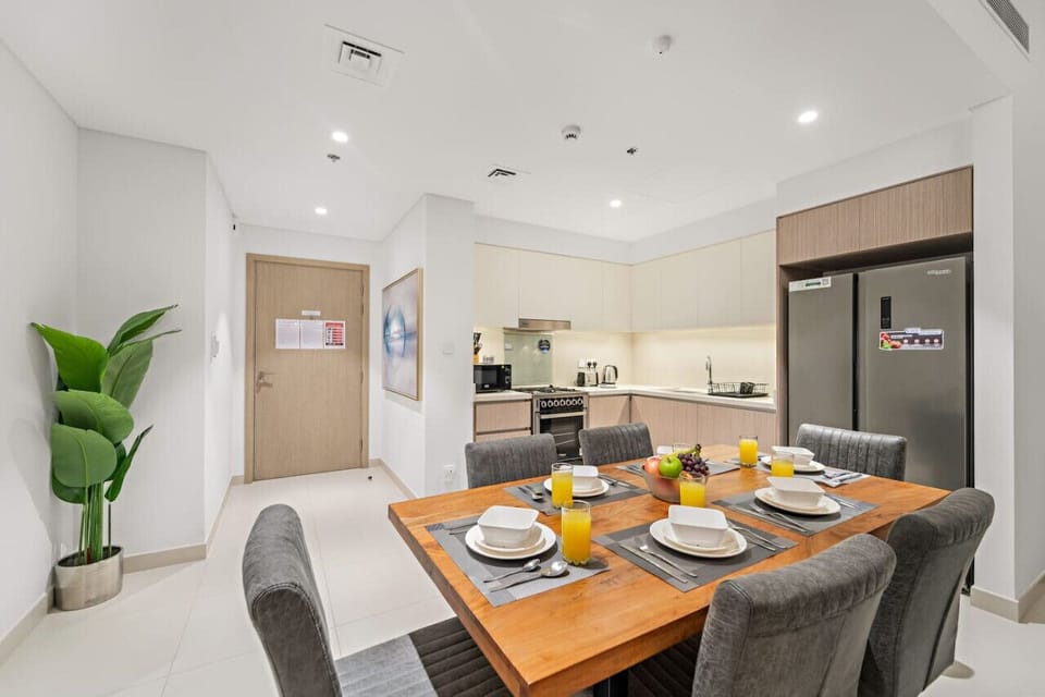 Enjoy meals in the chic dining area, featuring a modern table and comfortable seating for six. Perfect for casual breakfasts or elegant dinners, this space invites you to relax and savor every moment of your stay.