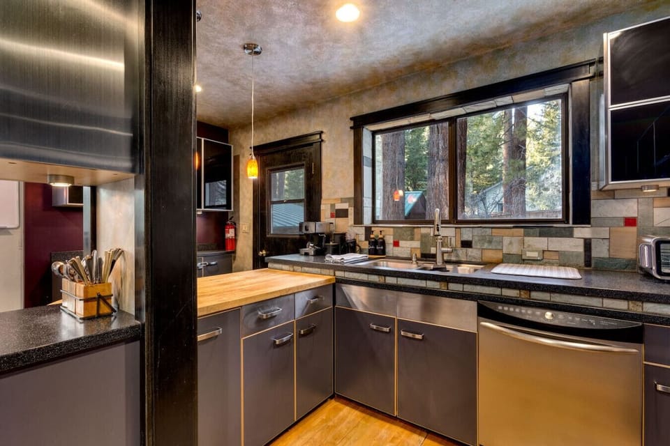 A kitchen designed for cooking, with sleek countertops and great views from the window.