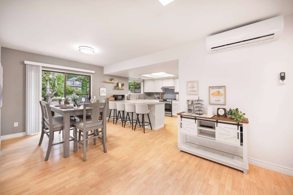 Light-filled space with seamless kitchen-to-dining flow, perfect for gatherings.