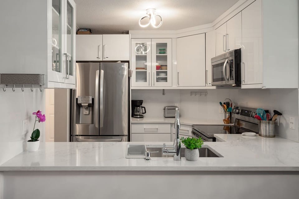 Fully equipped kitchen with modern, stainless steel appliances and everything you need to cook at home.