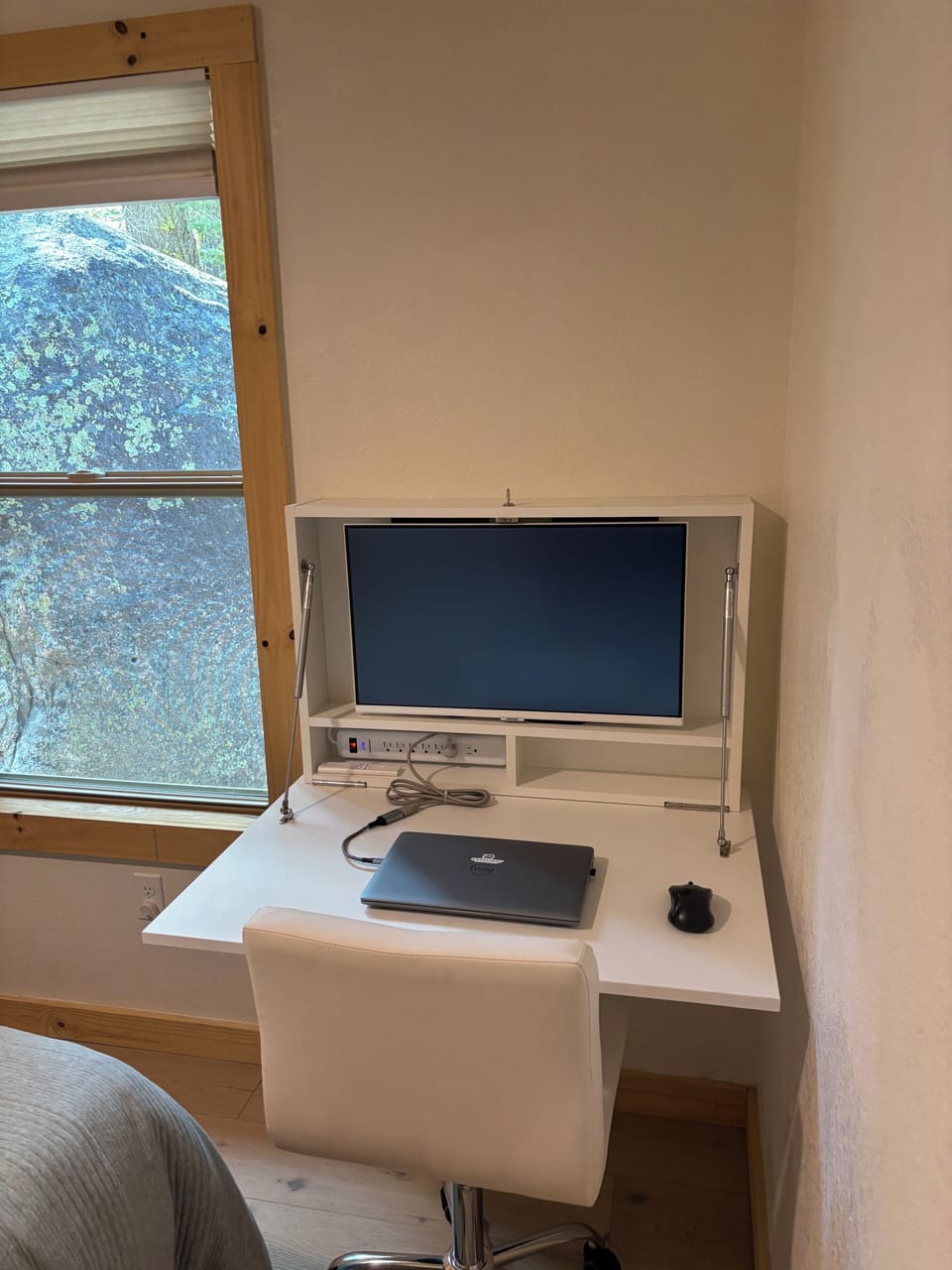 Pull down desk with monitor/TV and office chair.