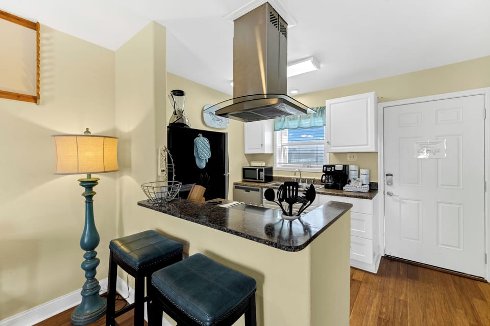 Your fully equipped kitchen features granite countertops, stainless appliances, and a breakfast bar where you can sip morning coffee.