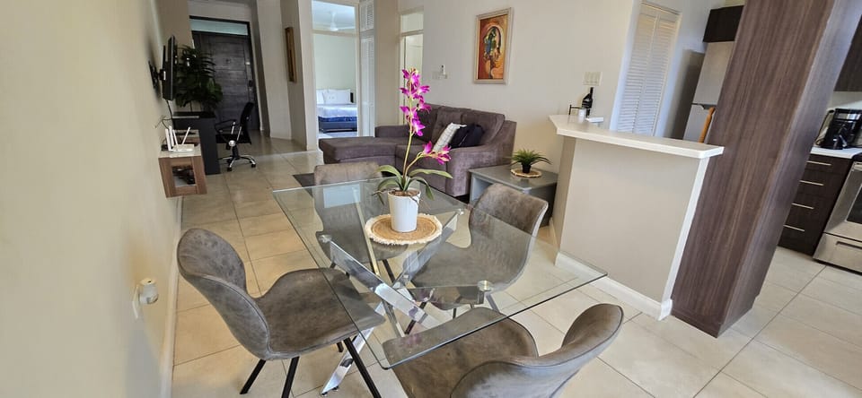 Inviting dining area w/ stylish chairs & floral centerpiece flowing into the cozy living room